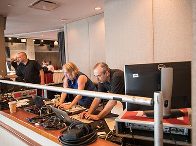 People with computers working on event production.